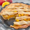 A Peach Mango Pie with a piece cut out of it