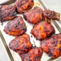 Smoked Chicken Thighs after cooking lined up on a baking sheet