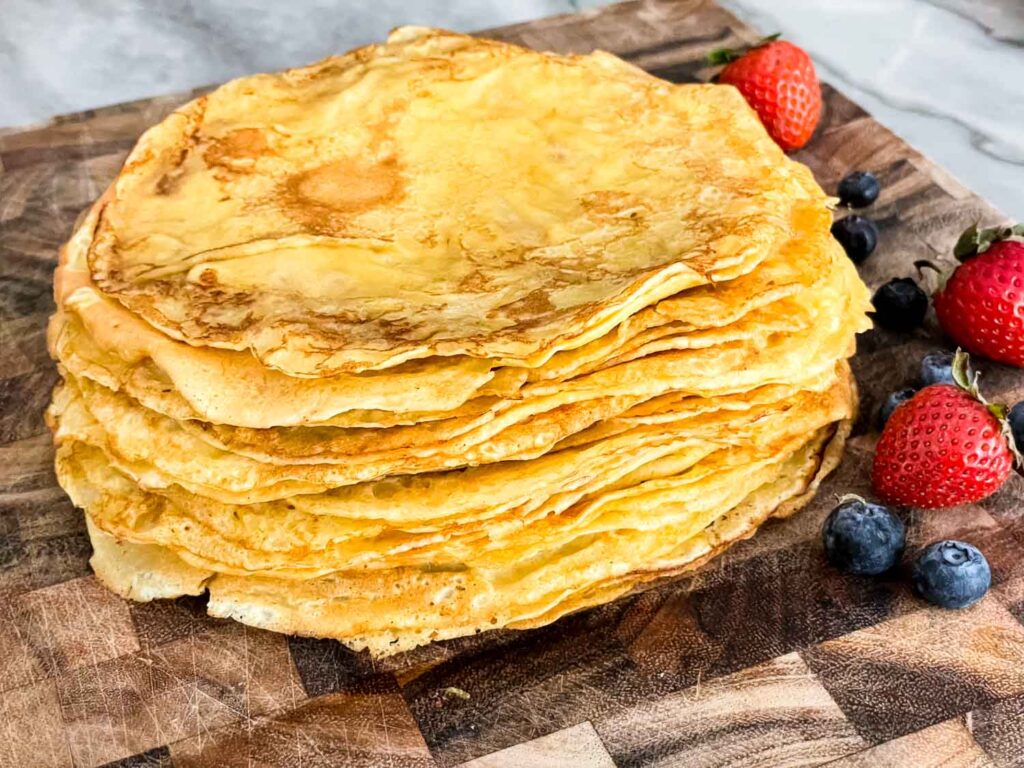 Sweet Crepes stacked up on a cutting board