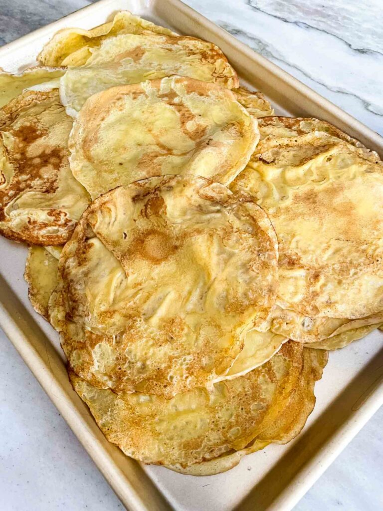 Sweet Crepes spread out on a baking sheet