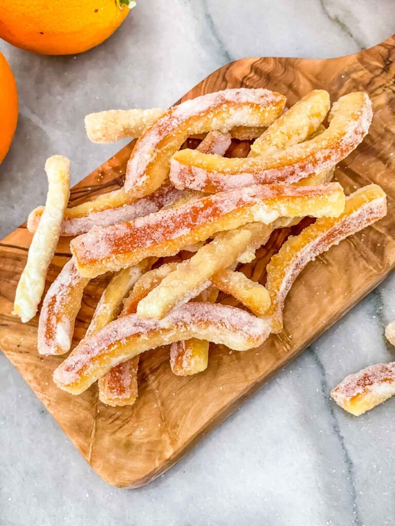 Candied Orange Peels on a small cutting board