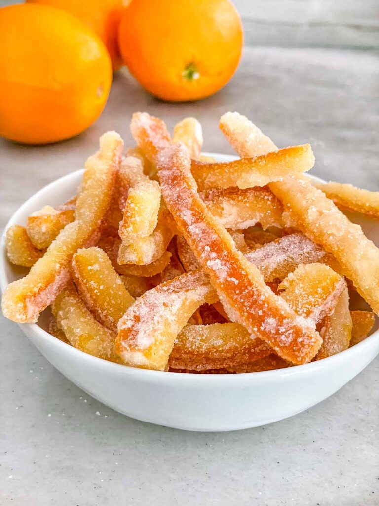 Candied Orange Peel piled up in a small bowl on a counter