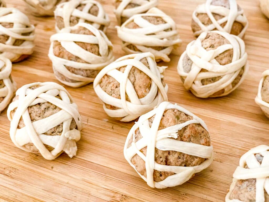 The meatballs with the dough wound around them ready to bake