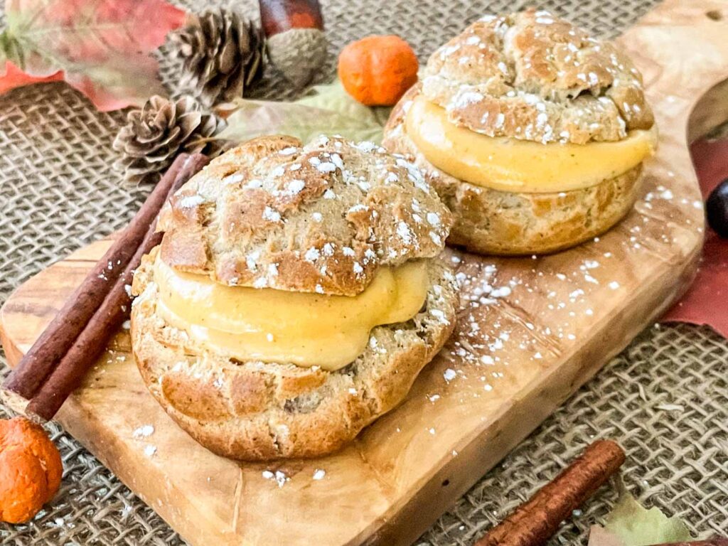 Pumpkin Spice Cream Puffs on a small cutting board