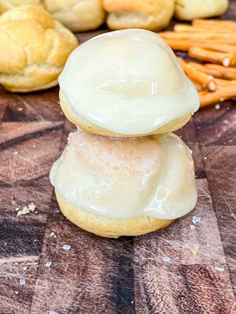 Two puffs coated in ganache and stacked