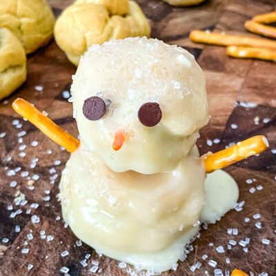 A Snowman Cream Puff on a cutting board