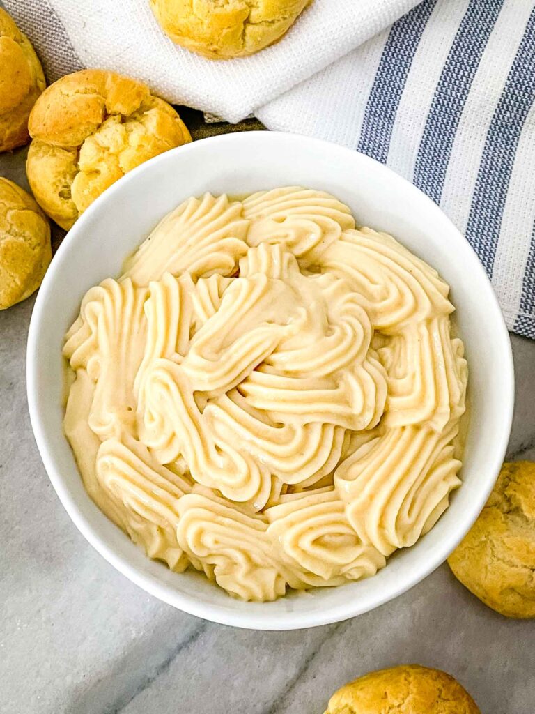 Vanilla Pastry Cream piped into a white bowl from the top view