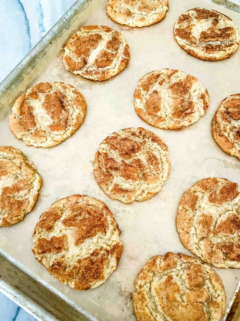 Chewy Snickerdoodle Cookies on a baking sheet after cooking