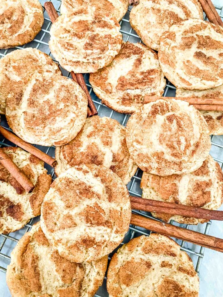 A pile of Chewy Snickerdoodle Cookies on a cooling rack