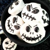 Jack Skellington Chocolate Covered Oreos piled in a cauldron