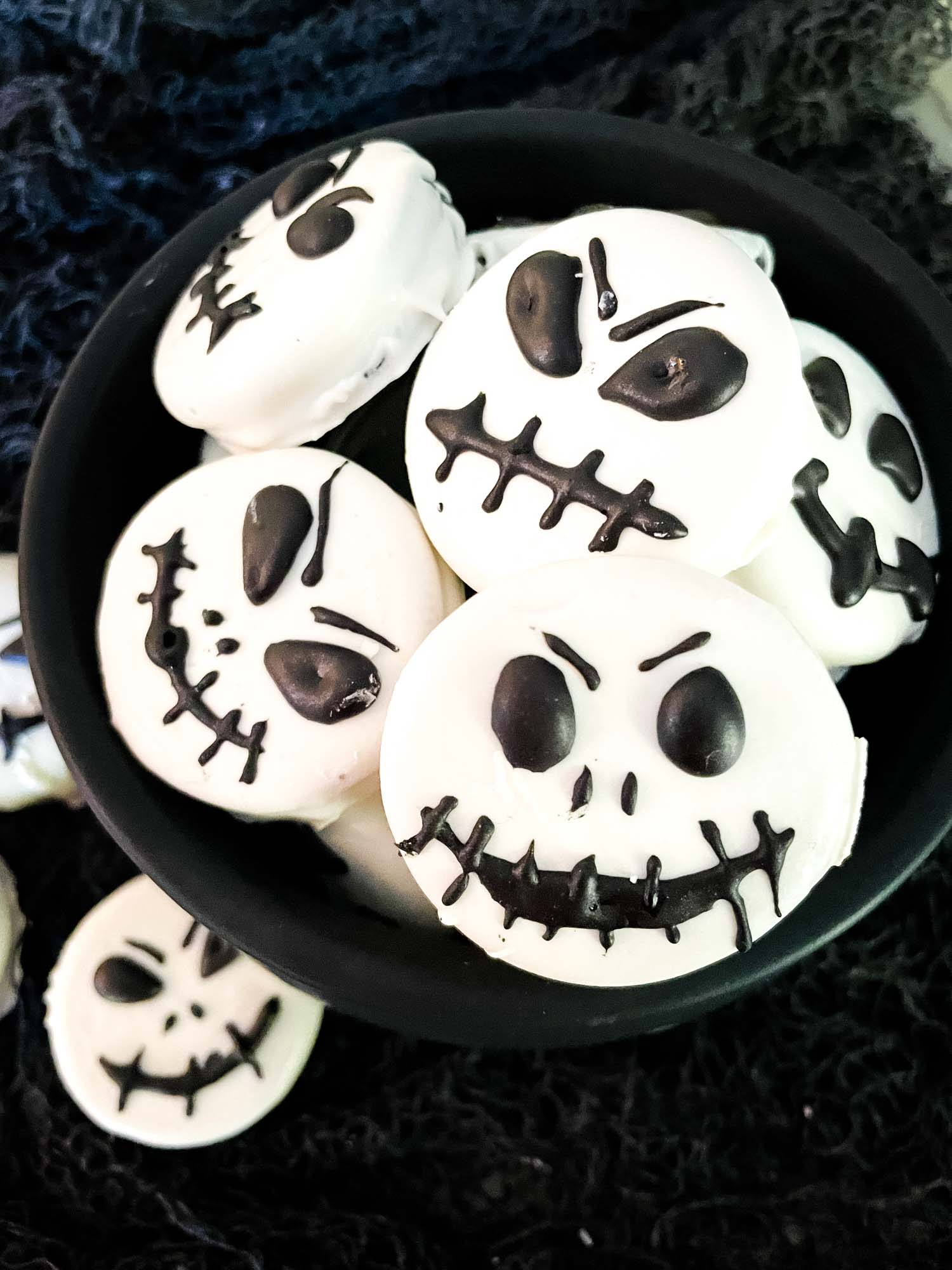 Jack Skellington Chocolate Covered Oreos piled in a cauldron