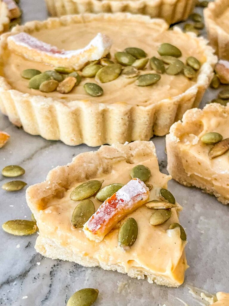 A wedge of a Pumpkin Tart with more behind it