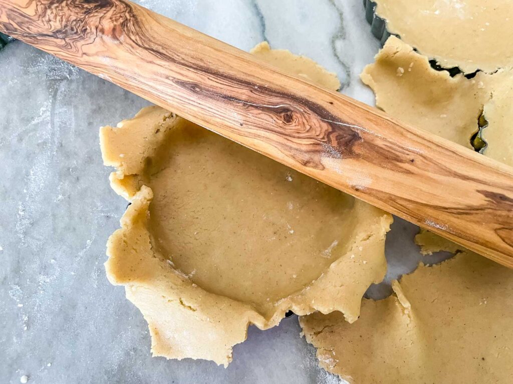 Rolling the excess dough off the top of the tart pan