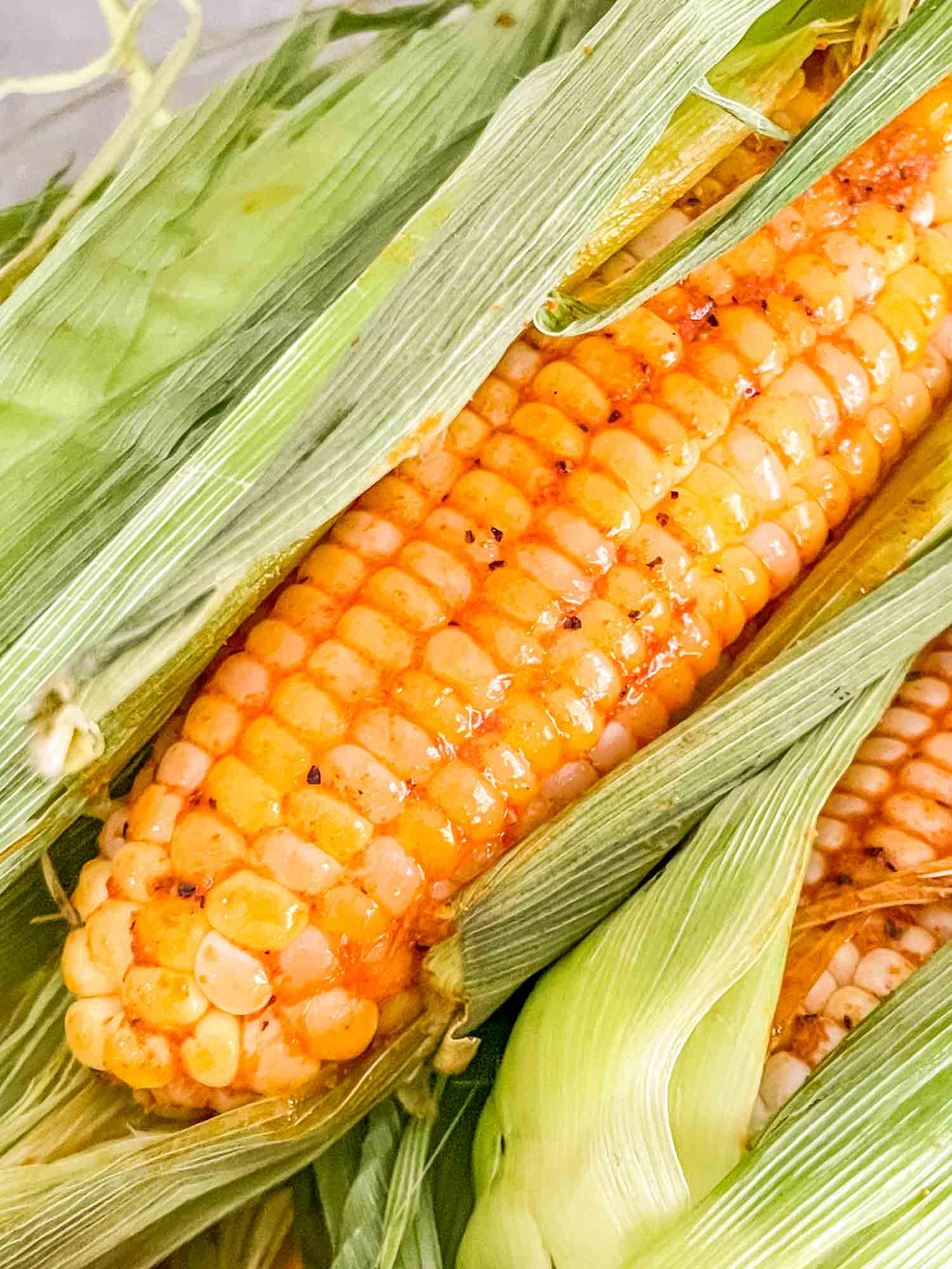 Close up of a Smoked Corn on the Cob in its husk
