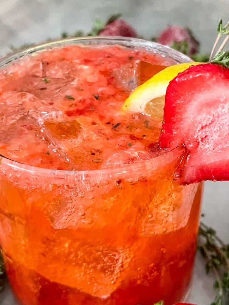 Close up of Strawberry Thyme Cooler (Non-Alcoholic Mocktail) in a glass