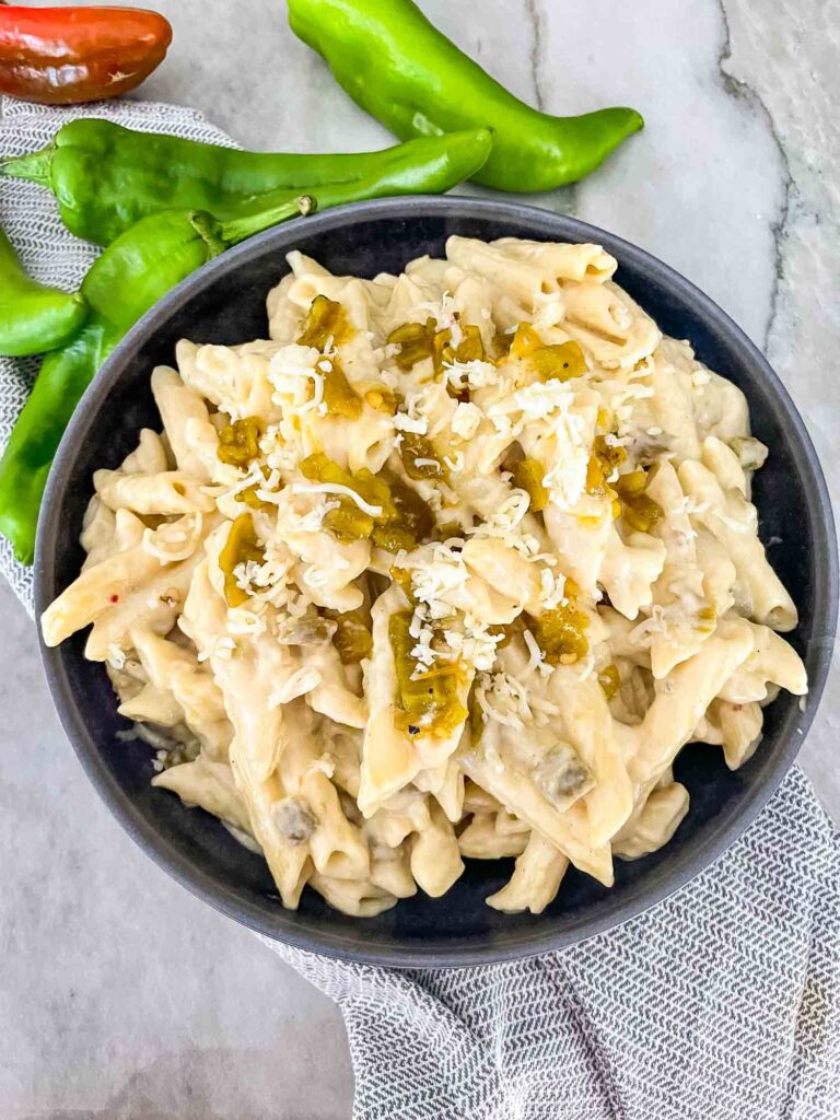 Top view of Hatch Green Chile Mac and Cheese in a dark bowl on a counter