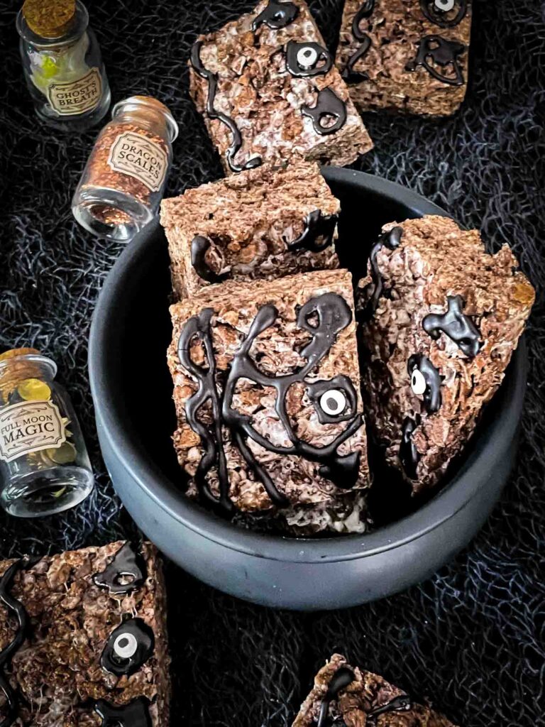 Hocus Pocus Spell Book Rice Krispie Treats sitting in a black cauldron