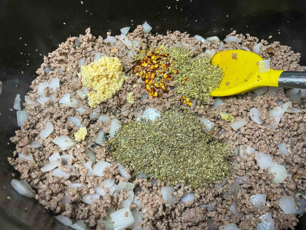 Mixing the meat with the spices in a pot