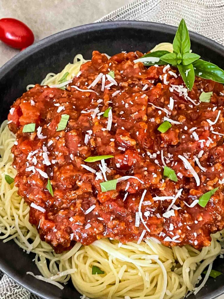 Meat Sauce on pasta in a gray bowl