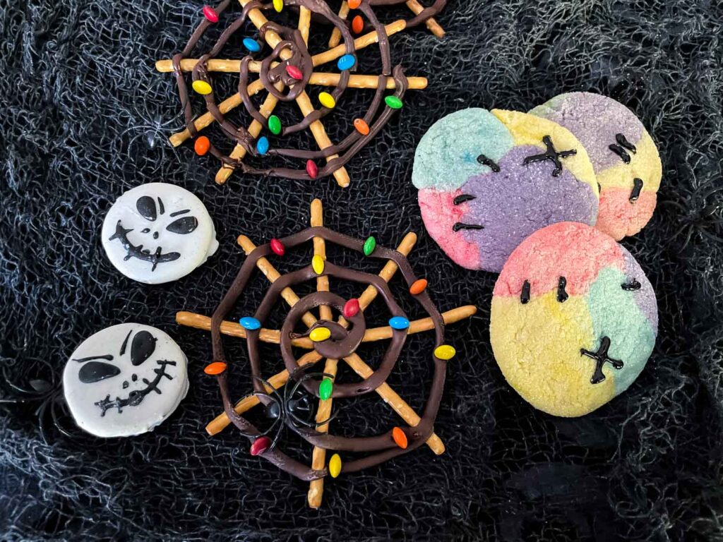 Nightmare Before Christmas spiderwebs, Jack Skellington Oreos, and Sally Sugar Cookies on black netting