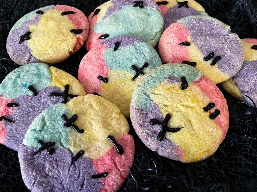 Nightmare Before Christmas Sally Sugar Cookies in a pile on black faric