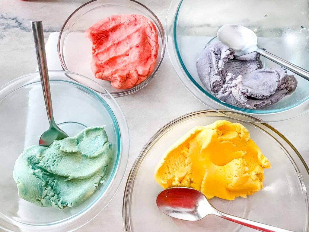 The four colored doughs in glass bowls ready to assemble