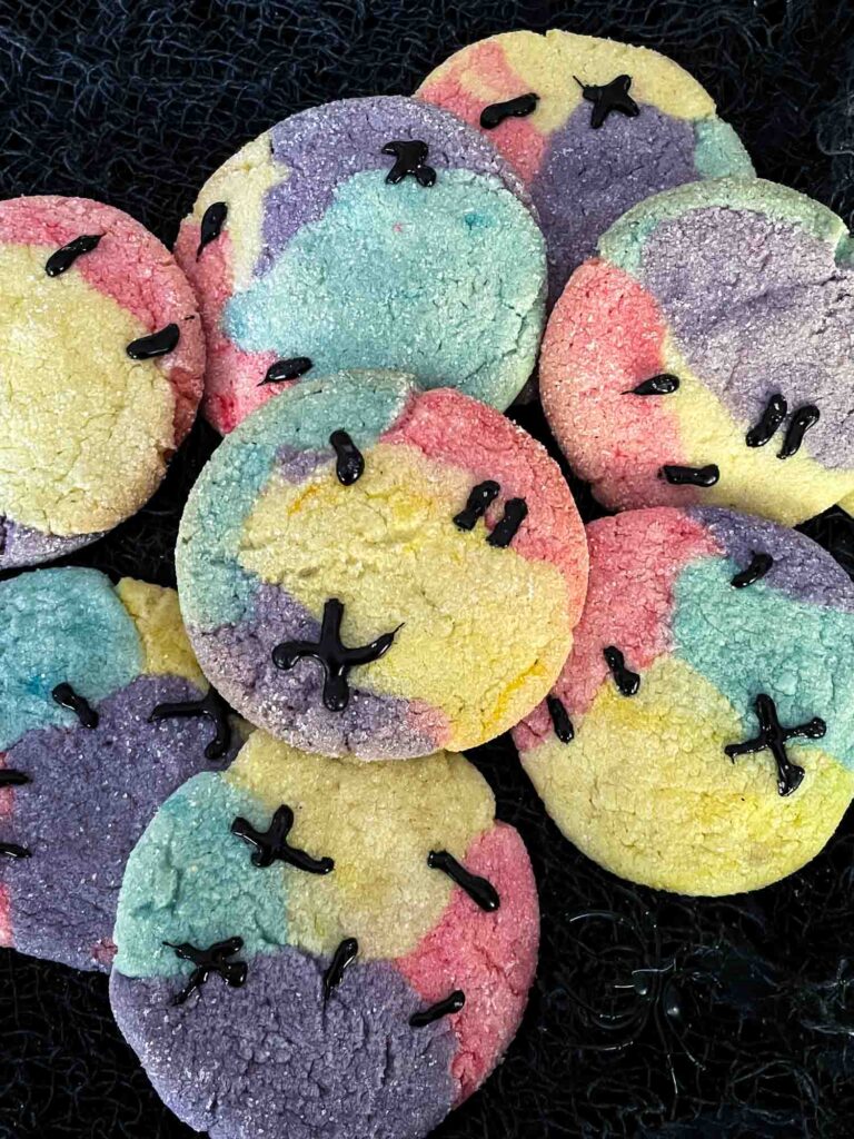Nightmare Before Christmas Sally Sugar Cookies in a pile on black fabric