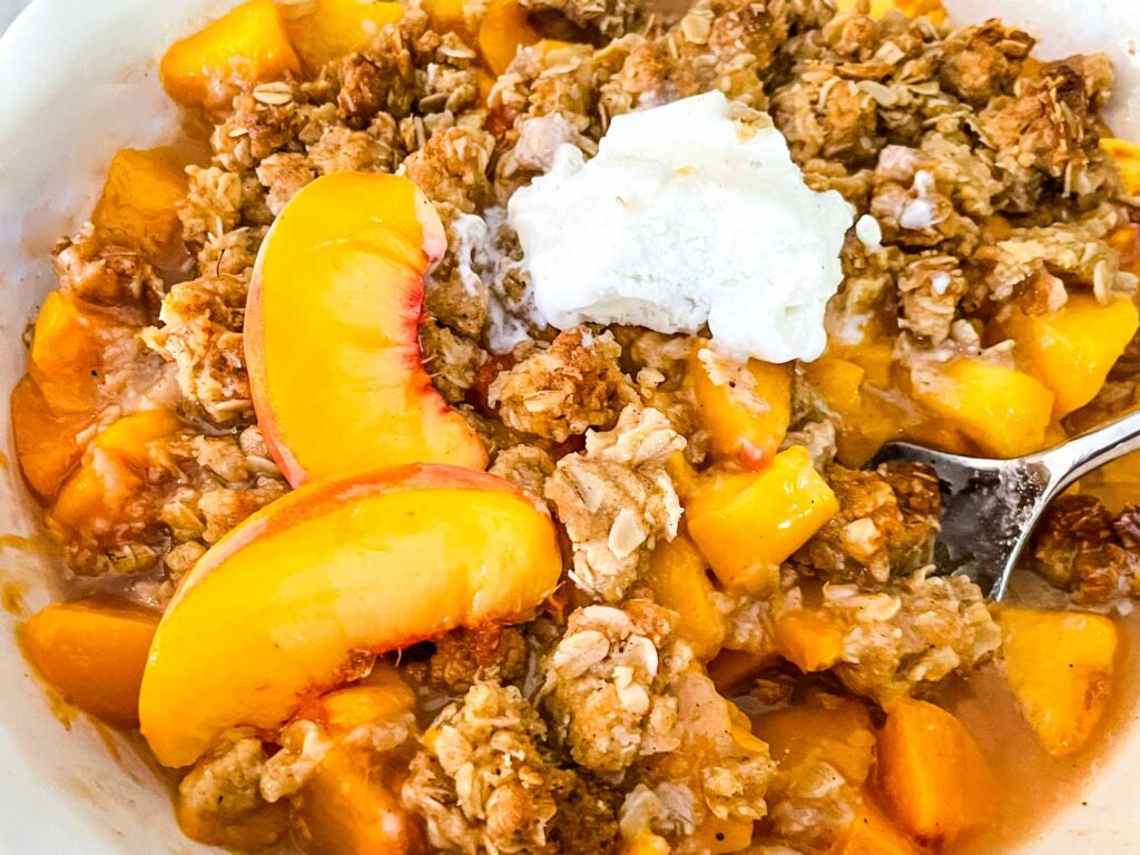 A pie dish full of Peach Crisp