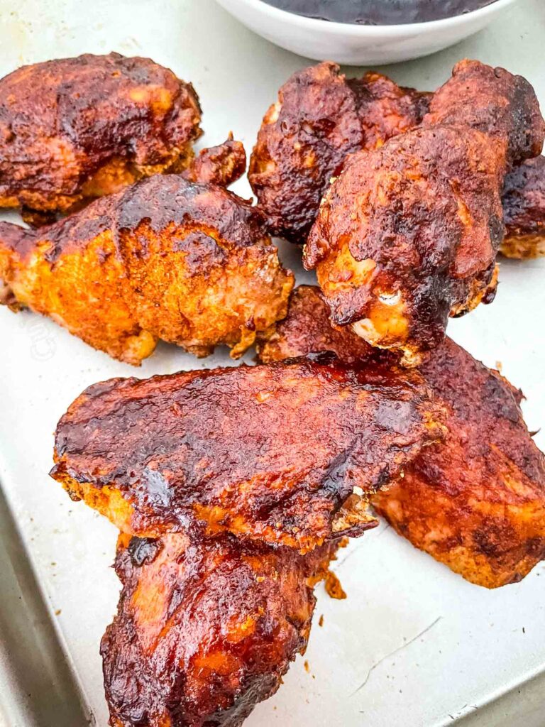 Smoked Chicken Wings in a pile on a white plate