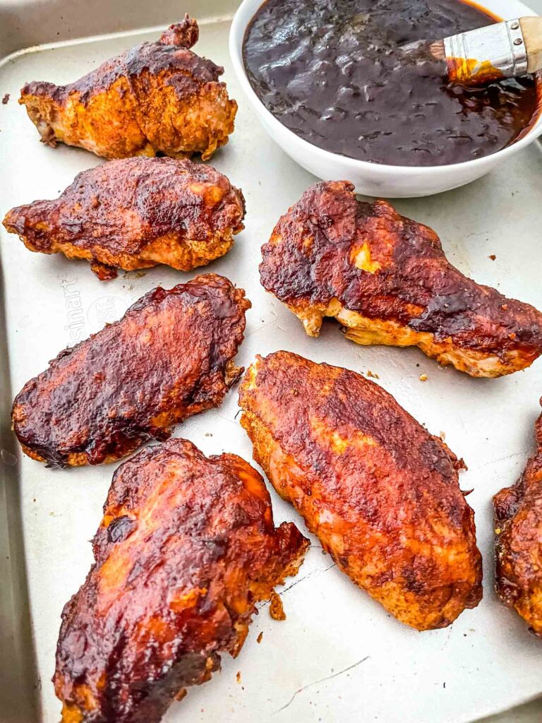 Smoked Chicken Wings spread out on a baking sheet