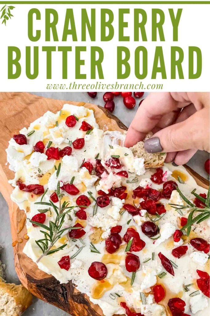 Pin of a hand dunking bread into a Cranberry Butter Board with title at top