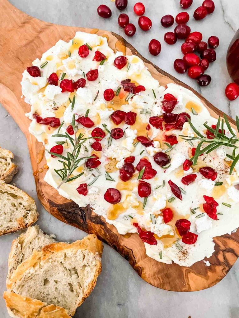 Cranberry Butter Board on a counter with bread around it