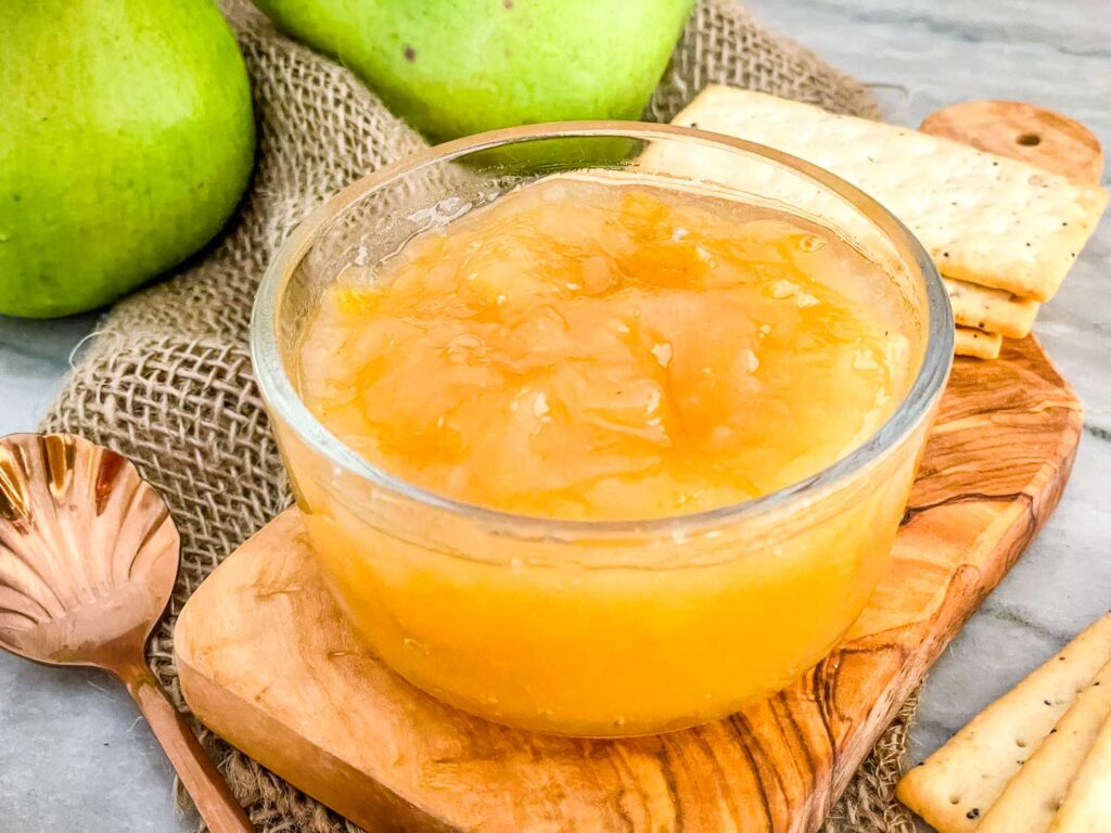 Pear Jam in a clear bowl on a piece of wood