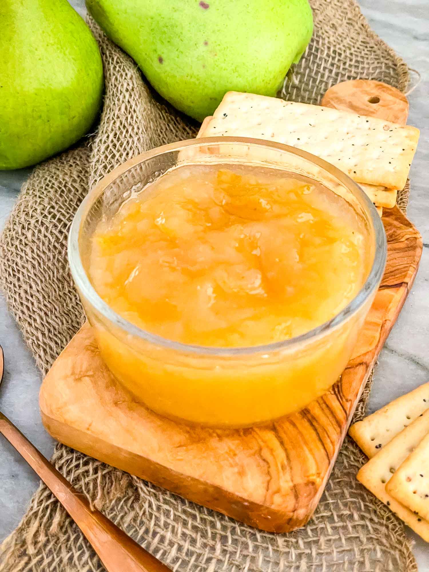 Pear Jam in a clear bowl sitting on wood