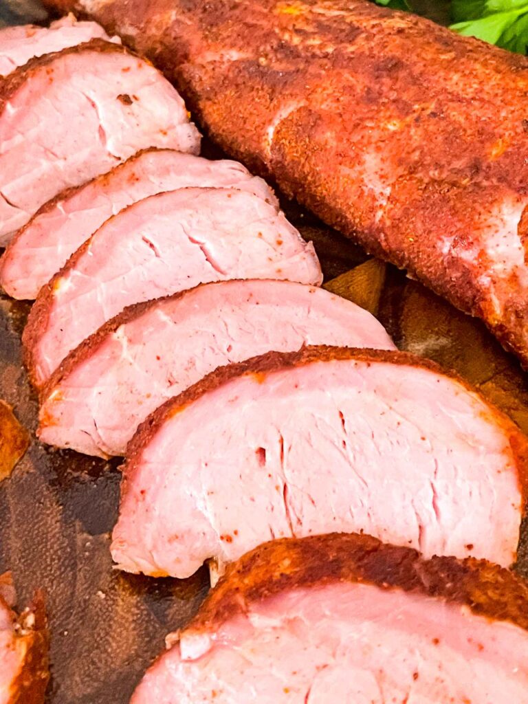 Close view of sliced Smoked Pork Tenderloin on a cutting board