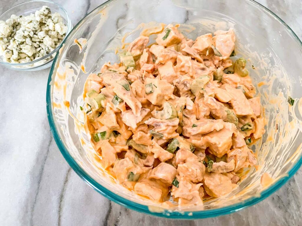 The mixed Buffalo Chicken Salad in a large clear bowl