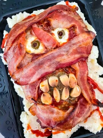 The finished Halloween Mummy Meatloaf on a black plate