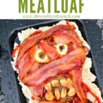 Pin of Halloween Mummy Meatloaf on a black platter with title at top