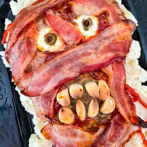 The finished Halloween Mummy Meatloaf on a black plate