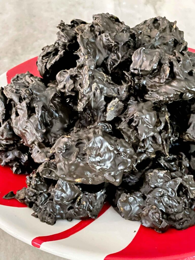 A mound of No Bake Lump of Coal Cookies on a red and white plate