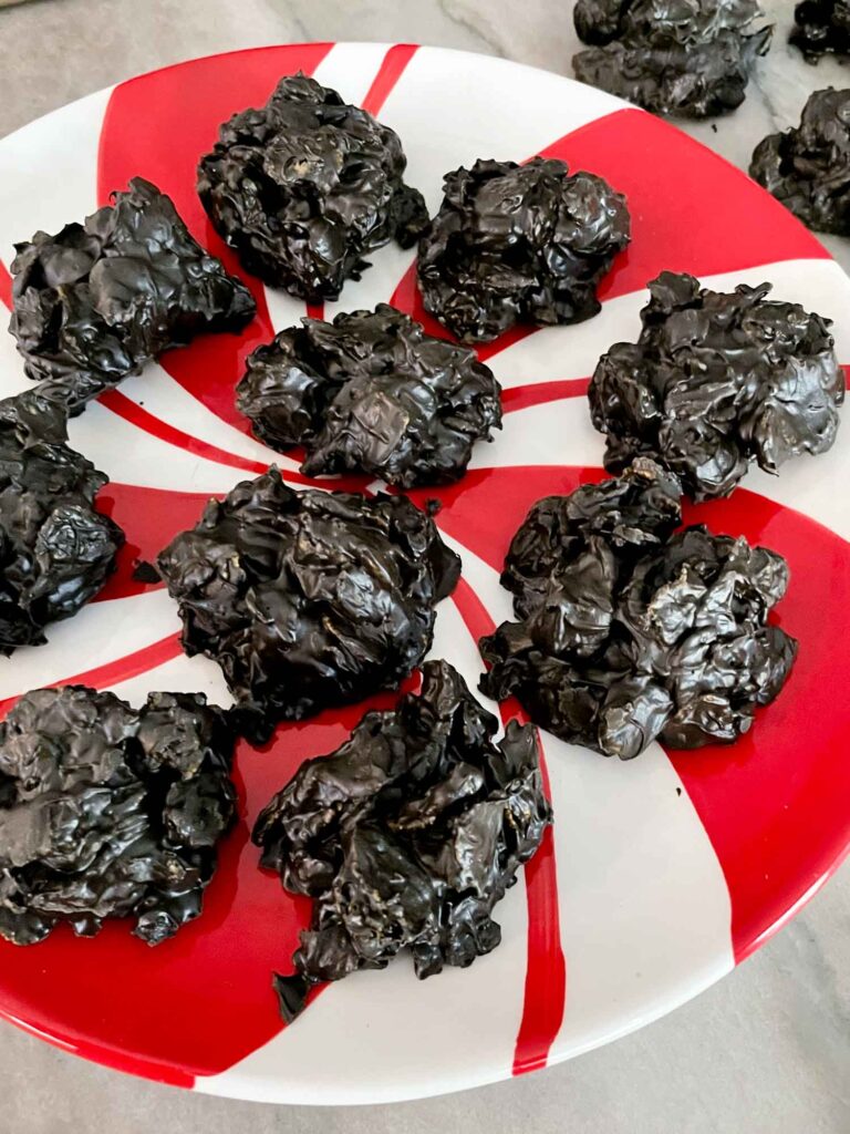 No Bake Lump of Coal Cookies sitting on a peppermint pattern plate