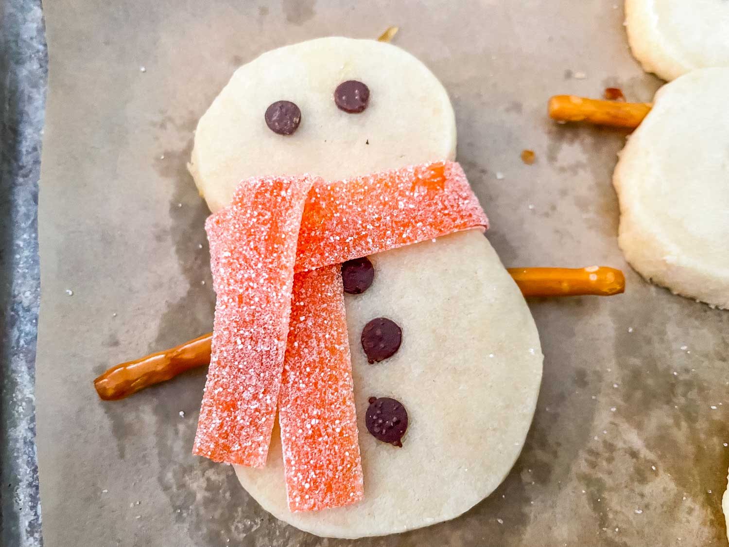 A snowman with his completed orange scarf