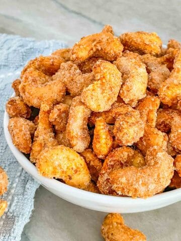 Close view of Sweet and Spicy Candied Cashews piled up in a bowl