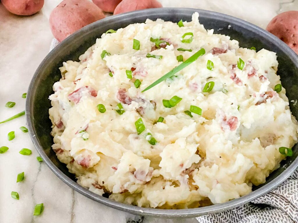 Red Skin Mashed Potatoes in a gray bowl on a counter