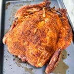 The Smoked Whole Chicken resting on a baking sheet after cooking