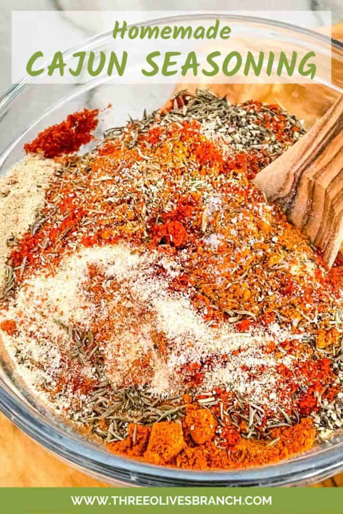 Pin of Homemade Cajun Seasoning being mixed in a bowl with title