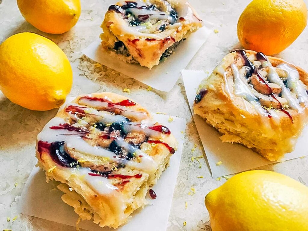 Blueberry Lemon Sweet Rolls on a counter with lemons