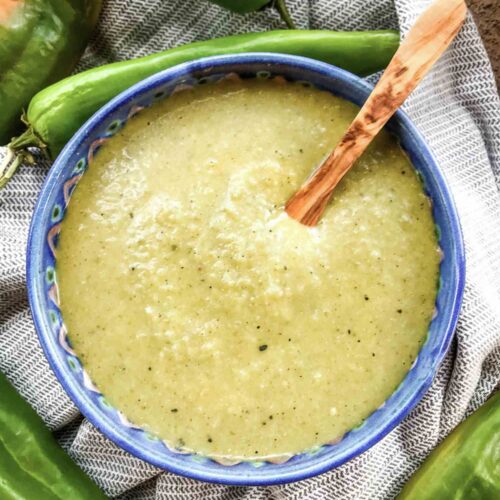 Top view of Hatch Chile Green Sauce for Enchiladas in a bowl with a small wood spoon