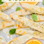 Pin of Basil Orange Biscotti in a pile with fresh basil and oranges with title at top