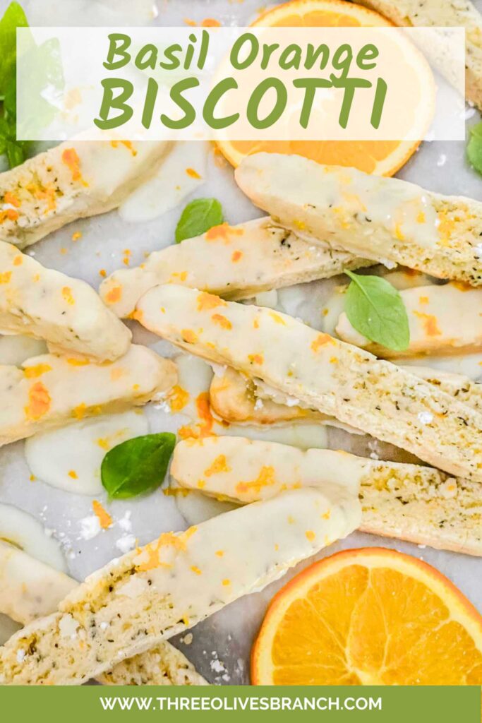 Pin of Basil Orange Biscotti in a pile with fresh basil and oranges with title at top